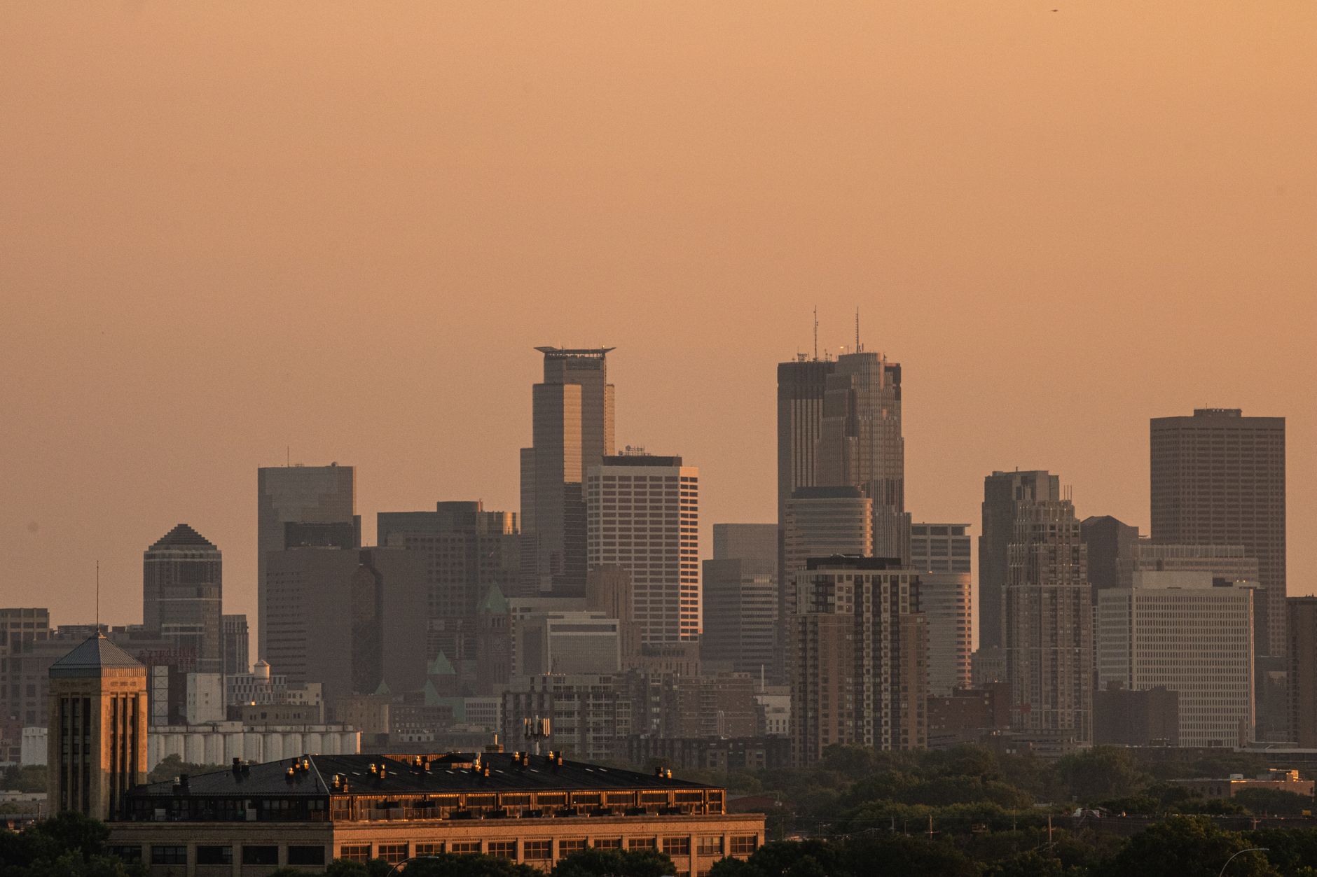 A Minnesota city skyline at dusk, seen across the river